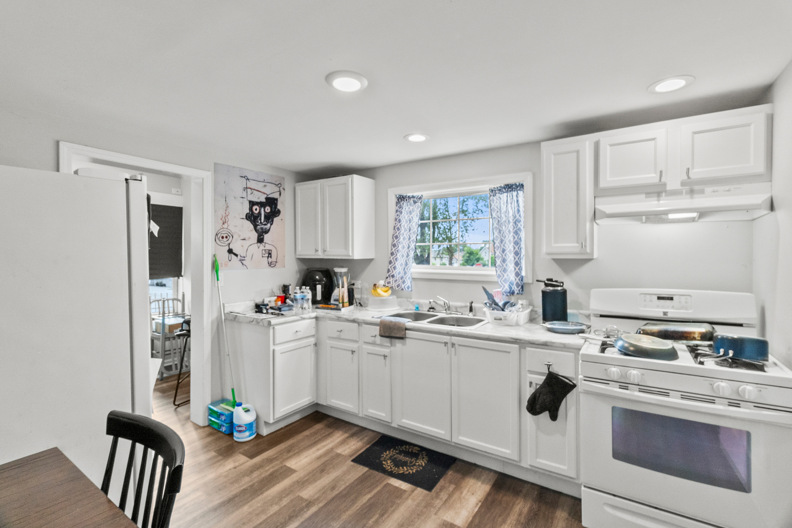 305 Irving Street Joliet, IL 60432 - Photo 6 of 20 a kitchen with stainless steel appliances a sink a stove a refrigerator cabinets and a window