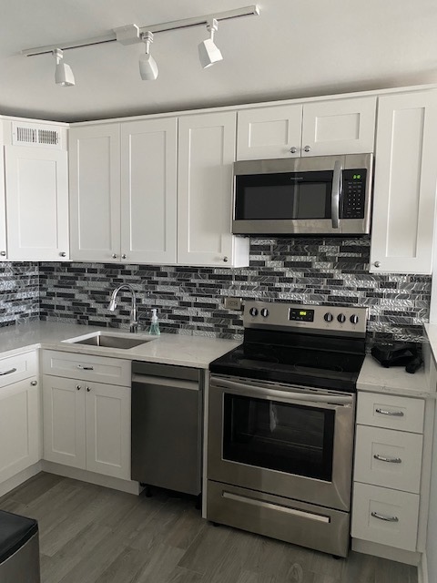 655 West Irving Park Road, Unit 2611 Chicago, IL 60613 - Photo 13 of 32 a kitchen with stainless steel appliances granite countertop a stove and a sink
