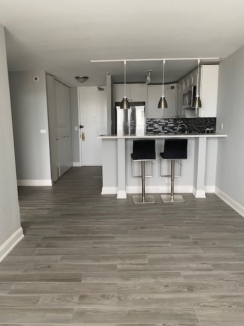 655 West Irving Park Road, Unit 2611 Chicago, IL 60613 - Photo 15 of 32 a kitchen with stainless steel appliances kitchen island sink refrigerator and stove