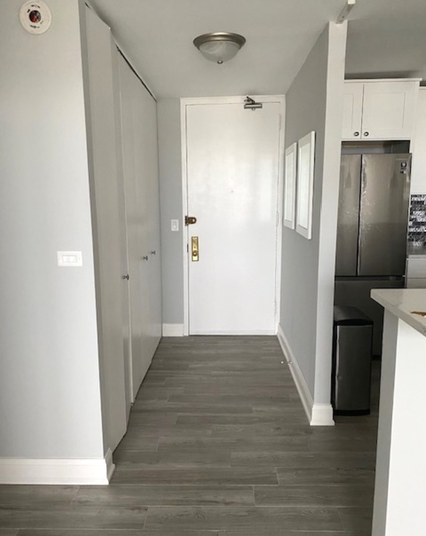 655 West Irving Park Road, Unit 2611 Chicago, IL 60613 - Photo 16 of 32 a view of a hallway with wooden floor