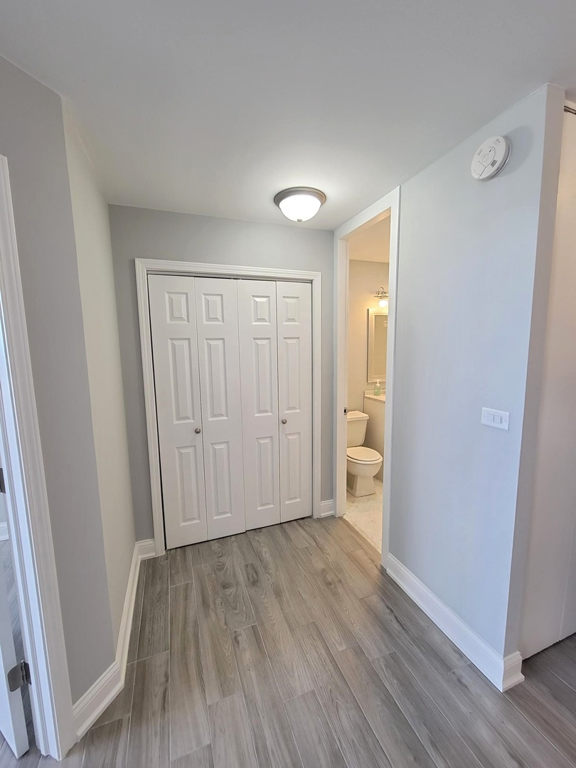 655 West Irving Park Road, Unit 2611 Chicago, IL 60613 - Photo 17 of 32 a view of an empty room with wooden floor and a window