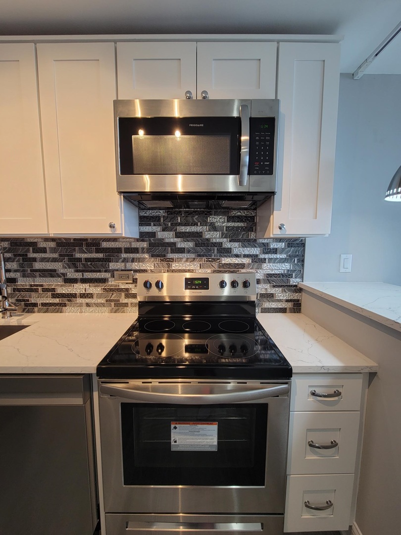 655 West Irving Park Road, Unit 2611 Chicago, IL 60613 - Photo 23 of 32 a stove top oven sitting inside of a kitchen