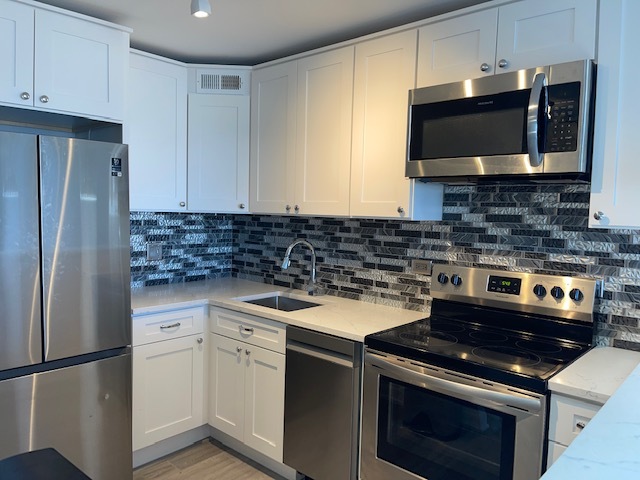 655 West Irving Park Road, Unit 2611 Chicago, IL 60613 - Photo 24 of 32 a kitchen with stainless steel appliances granite countertop a stove a microwave a refrigerator and cabinets