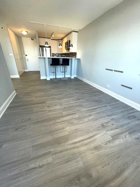655 West Irving Park Road, Unit 2611 Chicago, IL 60613 - Photo 28 of 32 a view of a room with wooden floor