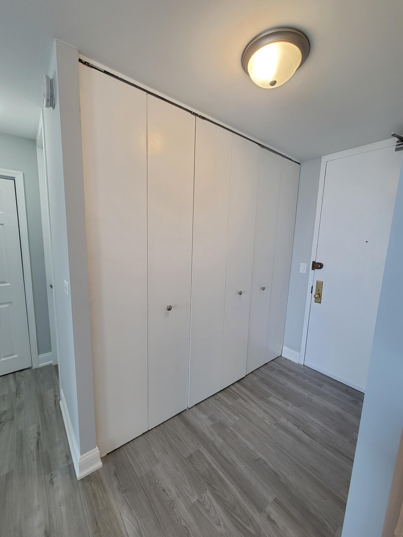 655 West Irving Park Road, Unit 2611 Chicago, IL 60613 - Photo 10 of 32 a view of an empty room with wooden floor
