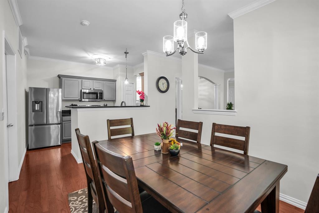 2524 Preston Road, Unit 808 Plano, TX 75093 - Photo 18 of 31 Dining area featuring wood flooring and a contemporary chandelier. Open to the kitchen.