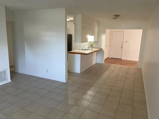 a view of a kitchen with a sink and a window