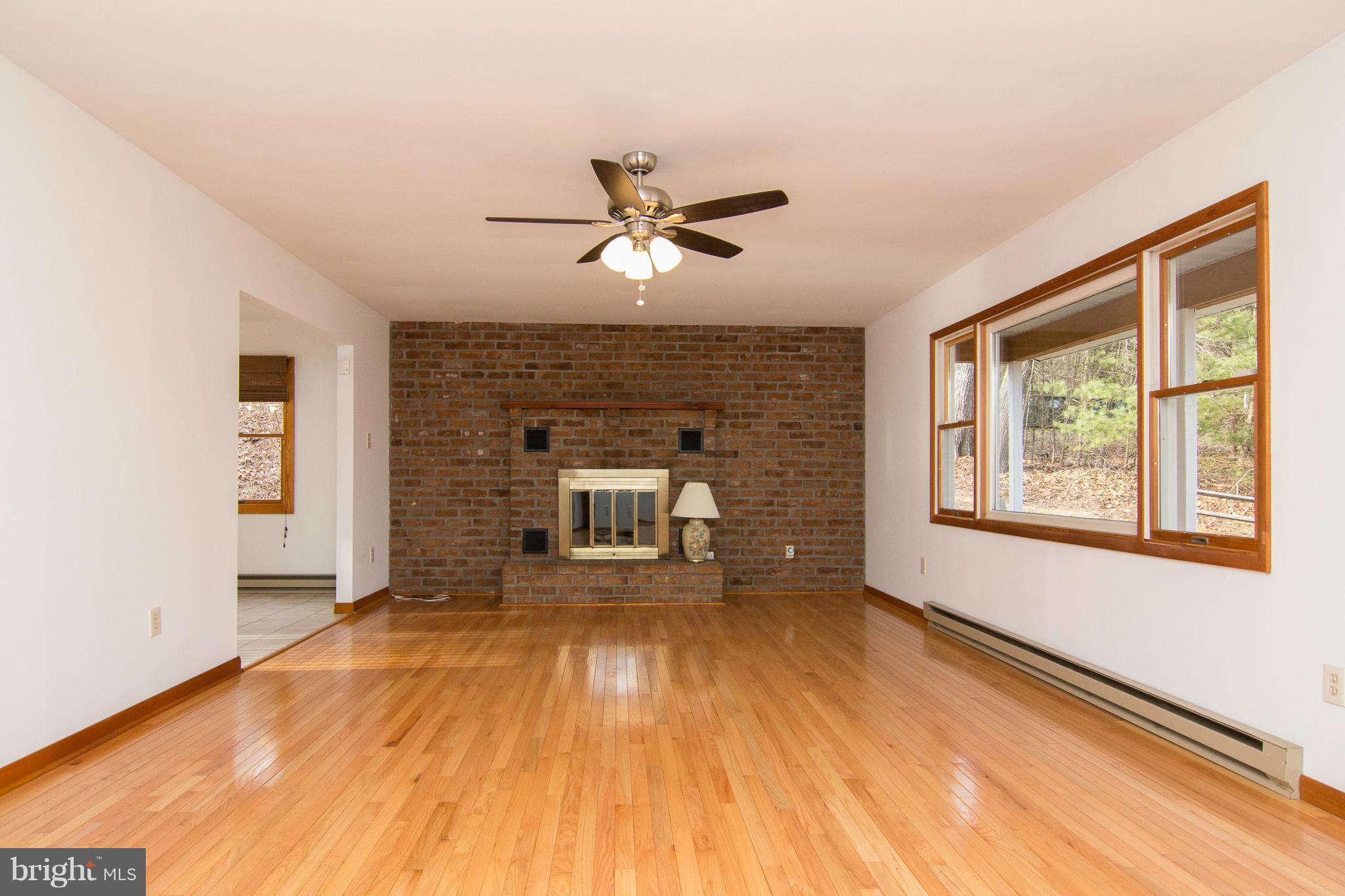 19306 Resh Mill Road Hampstead, MD 21074 - Photo 2 of 30 a living room with furniture and a fireplace