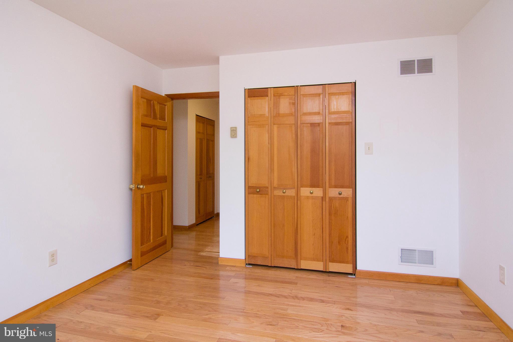19306 Resh Mill Road Hampstead, MD 21074 - Photo 16 of 30 an empty room with wooden floor and closet