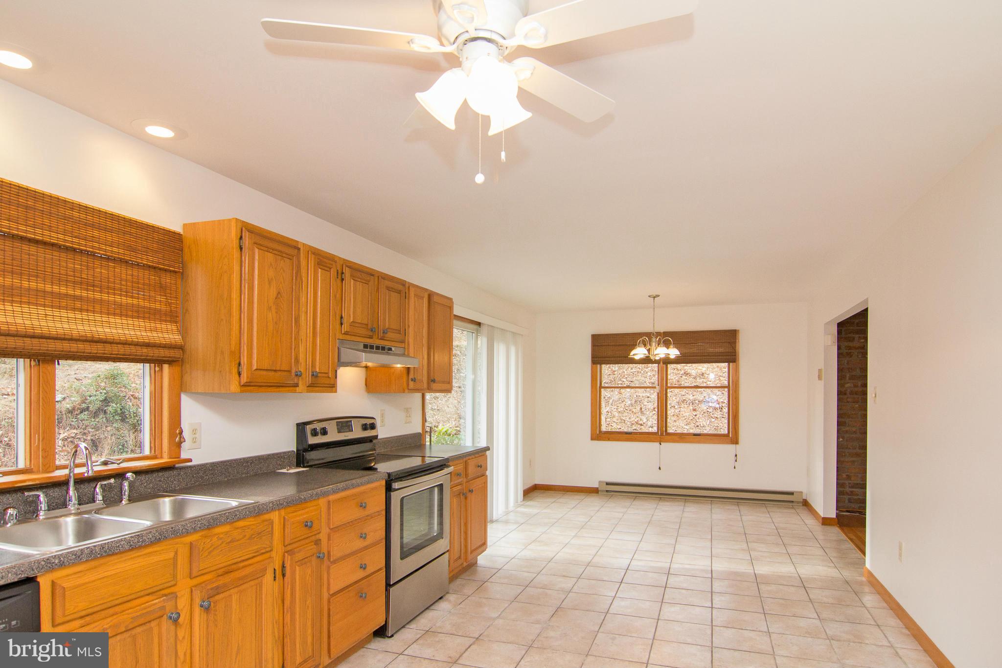 19306 Resh Mill Road Hampstead, MD 21074 - Photo 4 of 30 a kitchen with stainless steel appliances granite countertop a stove a sink and a refrigerator