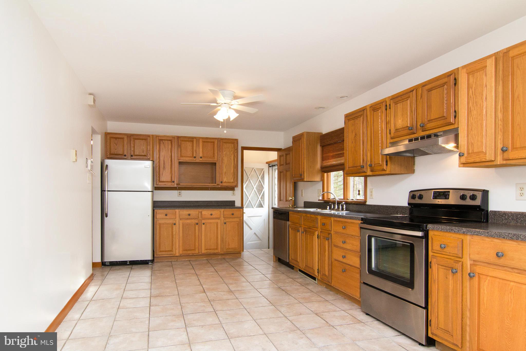19306 Resh Mill Road Hampstead, MD 21074 - Photo 5 of 30 a kitchen with stainless steel appliances granite countertop a stove a sink and a refrigerator