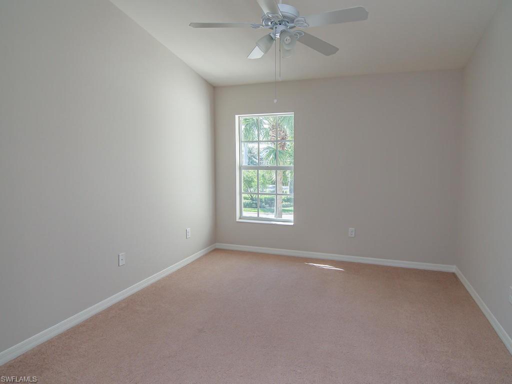 16170 Caldera Lane, Unit 37 Naples, FL 34110 - Photo 15 of 23 an empty room with a window and a fan