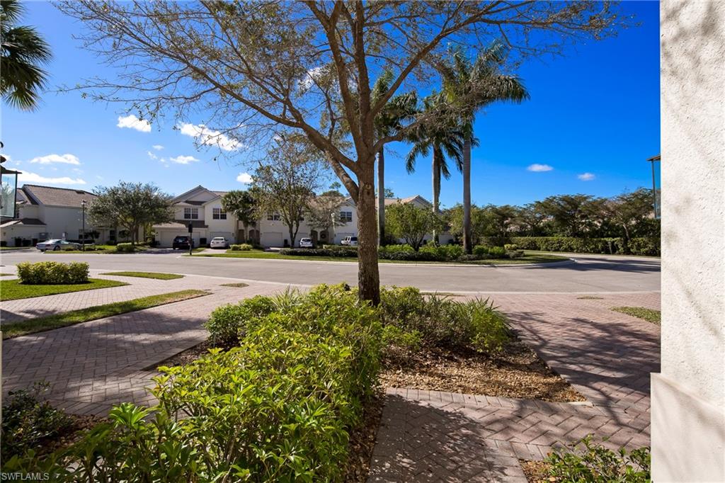 16170 Caldera Lane, Unit 37 Naples, FL 34110 - Photo 2 of 23 a view of backyard with green space