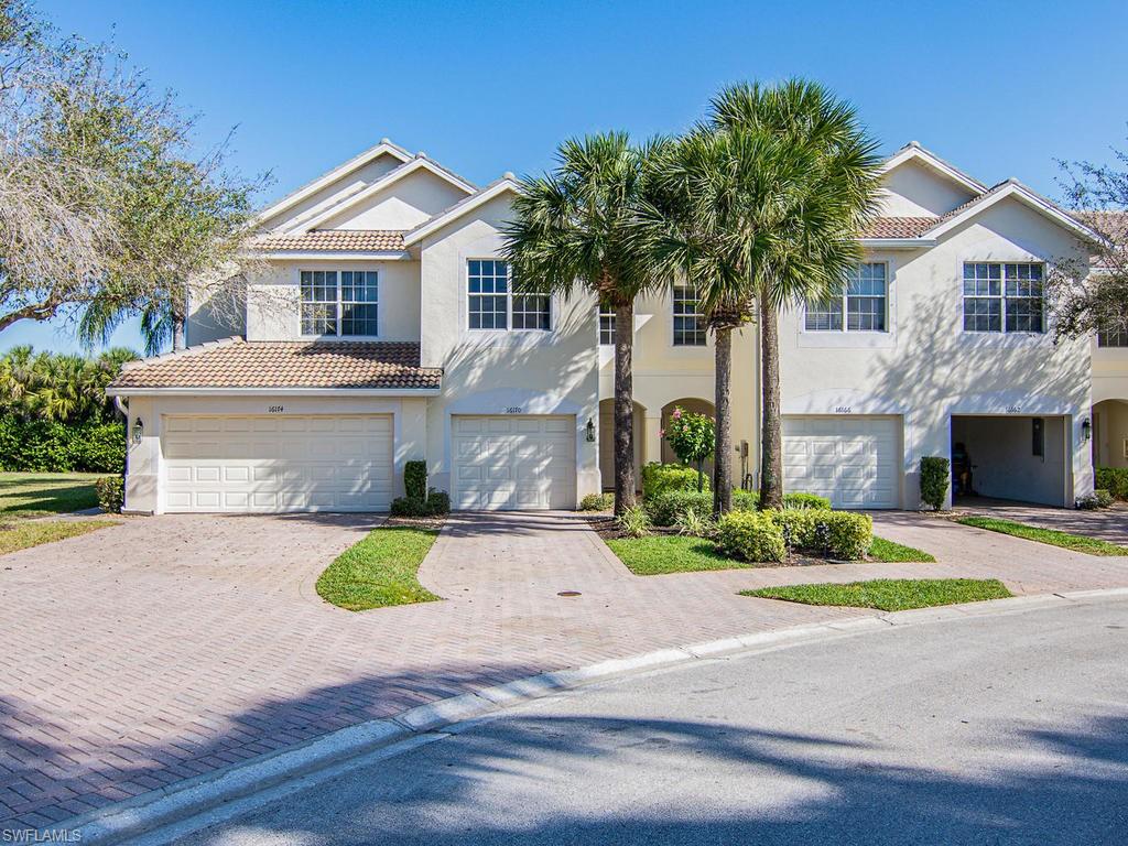 16170 Caldera Lane, Unit 37 Naples, FL 34110 - Photo 4 of 23 a front view of a house with a yard and garage
