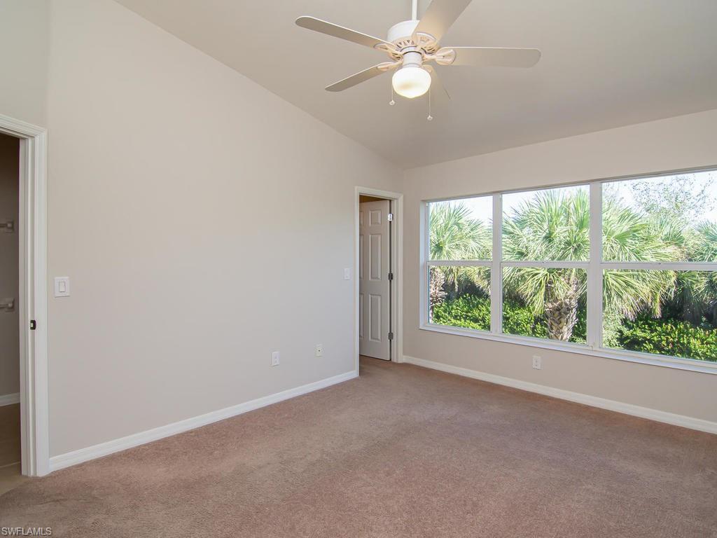 16170 Caldera Lane, Unit 37 Naples, FL 34110 - Photo 10 of 23 an empty room with a large window with ceiling fan
