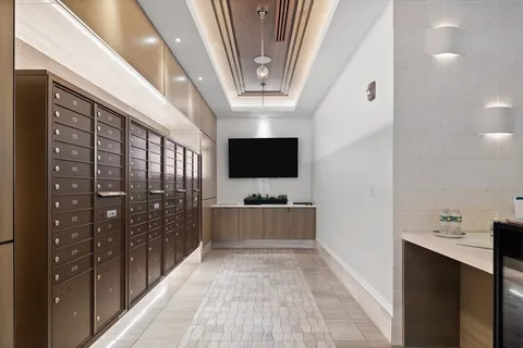 a view of a hallway with wooden floor and furniture
