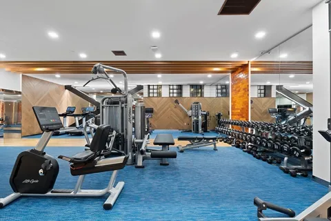 a room with lots of gym equipment and air hockey table