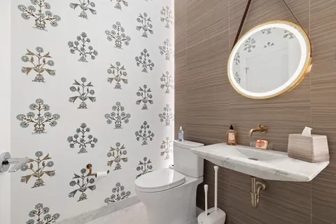 a bathroom with a sink a toilet and a mirror