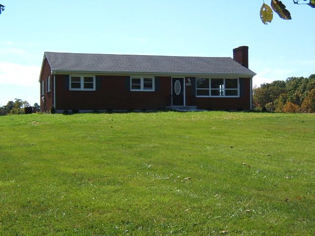 1161 Blankenship Road Goodview, VA 24095 - Photo 1 of 12 a front view of a house with a garden