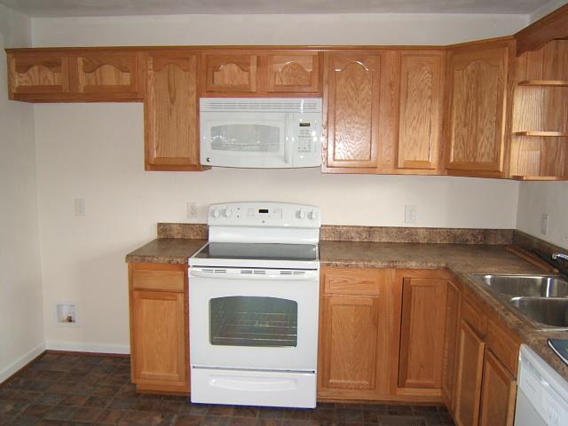 1161 Blankenship Road Goodview, VA 24095 - Photo 2 of 12 a kitchen with a stove top oven sink and cabinets