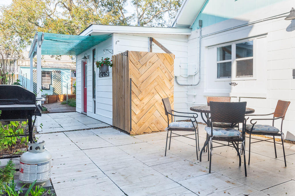 141 Miami Street Miramar Beach, FL 32550 - Photo 21 of 31 a patio with a table and chairs and potted plants
