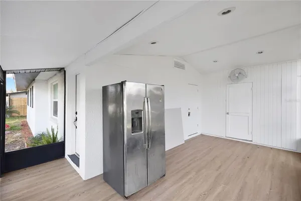 a view of a refrigerator in kitchen and wooden floor