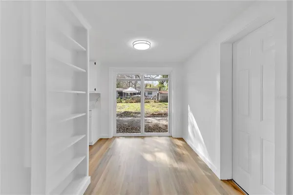 a view of gallery with wooden floor