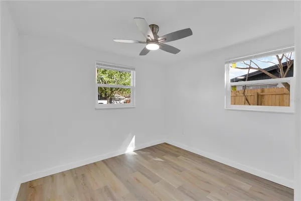 a view of empty room with wooden floor