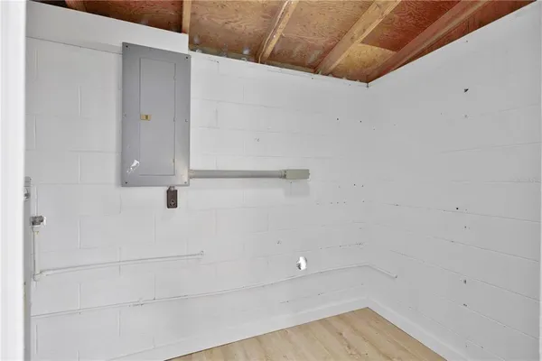 a view of a big room with wooden floor and a ceiling fan
