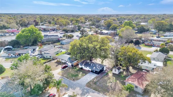 a aerial view of a residential houses with yard