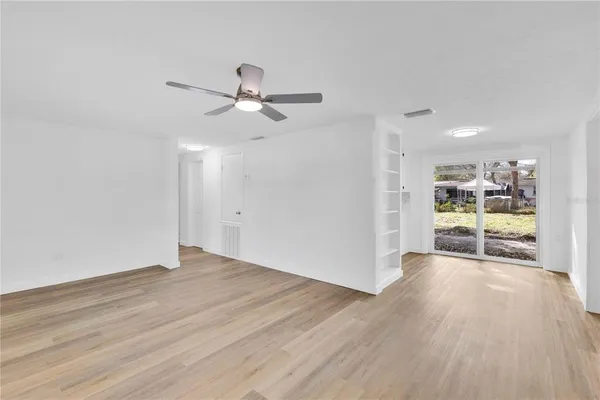 a view of a big room with wooden floor and windows in a room