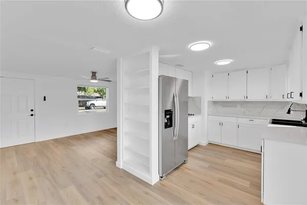 a view of a kitchen with wooden floor