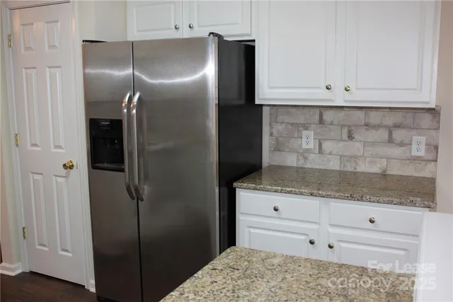 a view of a room that has wooden floor and a window