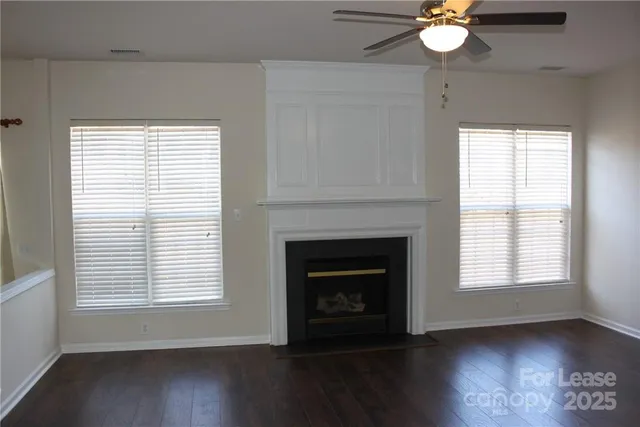 an empty room with wooden floor and a window