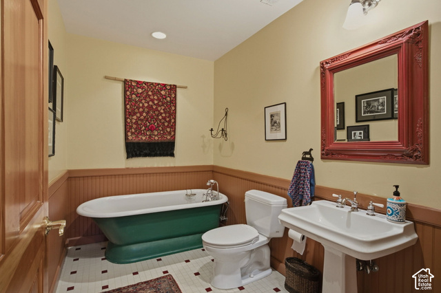 725 Canyon Road Smithfield, UT 84335 - Photo 44 of 100 Pedestal sink with chrome fixtures, wainscoting, a freestanding bathtub, and square floor tiles