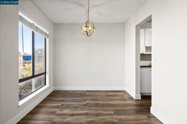 a view of a dining room with furniture and a potted plant