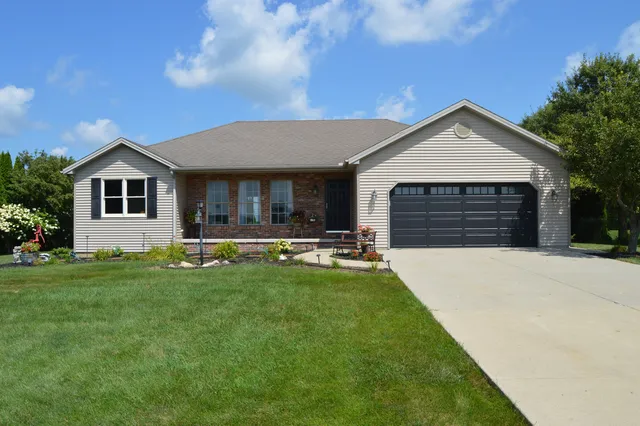 a front view of house with yard barbeque and outdoor seating