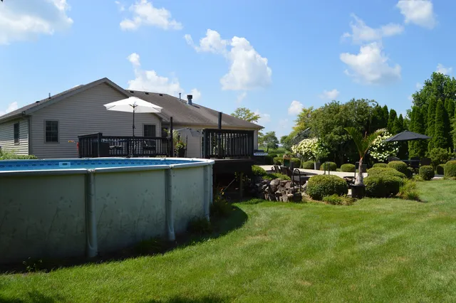an aerial view of a house with outdoor space lake view and sitting space