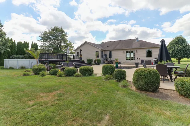 a view of a livingroom with a fireplace a chandelier and wooden floor