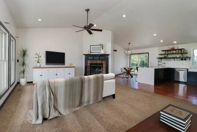 a view of a livingroom with furniture and a ceiling fan