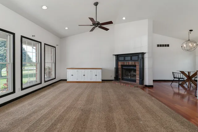 a kitchen with kitchen island stainless steel appliances a table and chairs in it