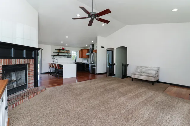a kitchen with stainless steel appliances granite countertop a refrigerator and a stove top oven