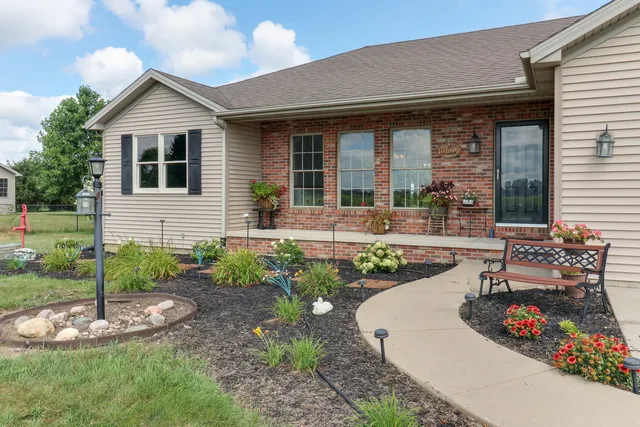 a front view of a house with garden and porch