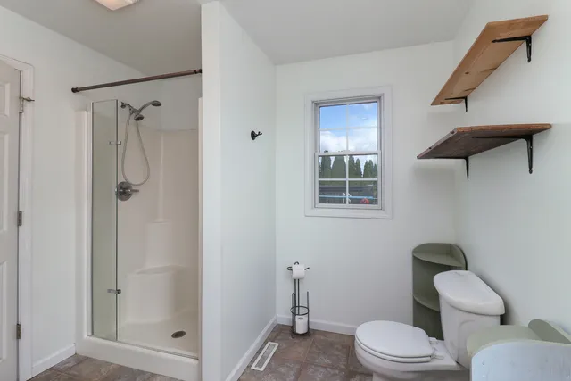 a bathroom with a sink a toilet a mirror and vanity