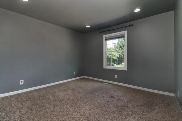 a view of room with furniture and a ceiling fan