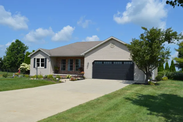 a front view of house with yard and green space