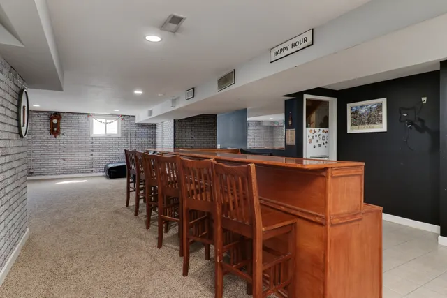 a view of a white house with a big yard and large trees