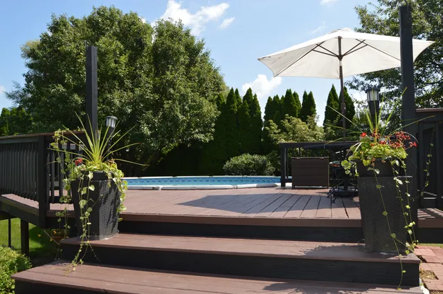 a front view of a house with a garden and yard