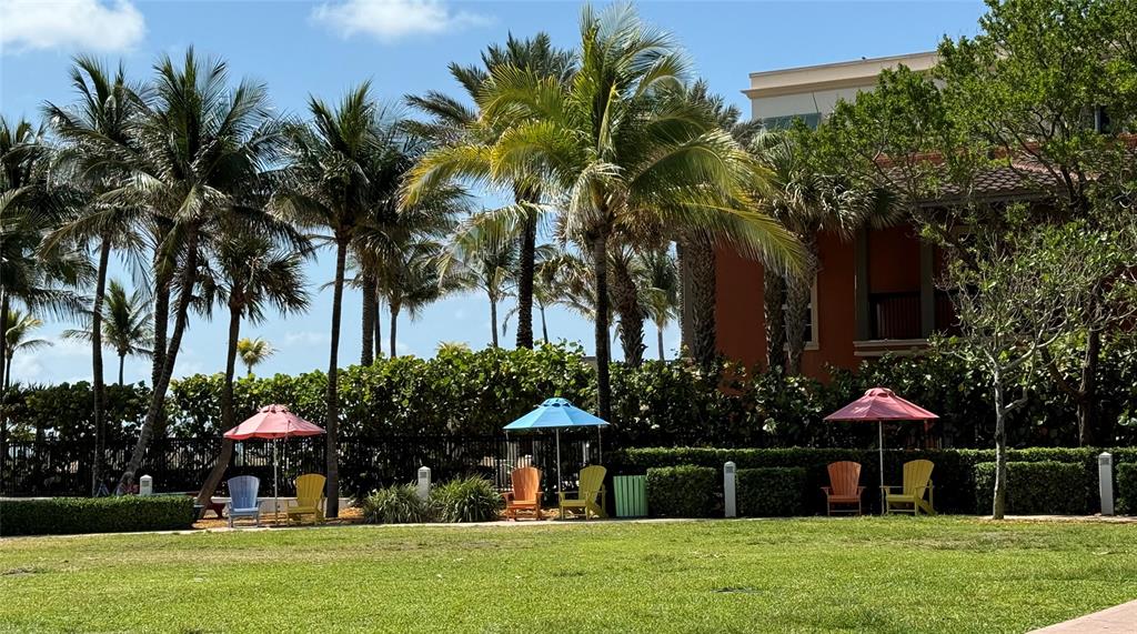 1541 South Ocean Boulevard, Unit 122 Pompano Beach, FL 33062 - Photo 26 of 30 a front view of a house with a garden and trees
