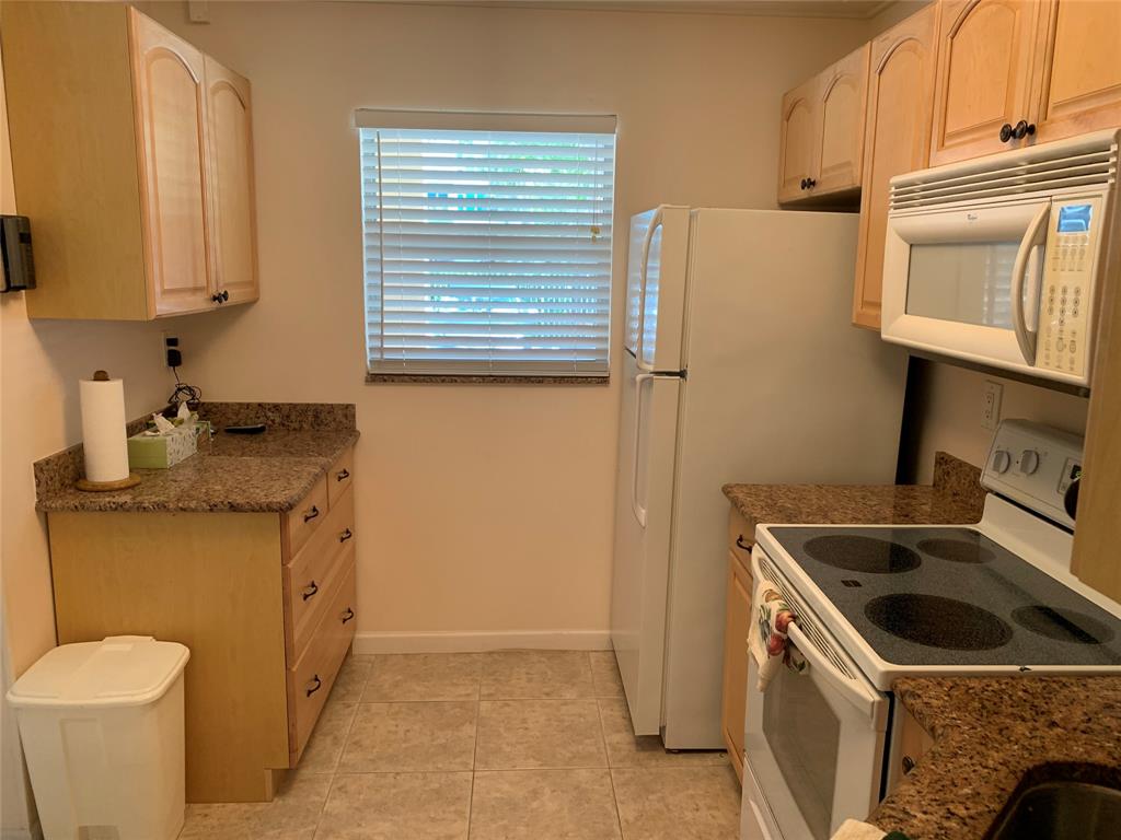 1541 South Ocean Boulevard, Unit 122 Pompano Beach, FL 33062 - Photo 5 of 30 a kitchen with a sink stove and refrigerator